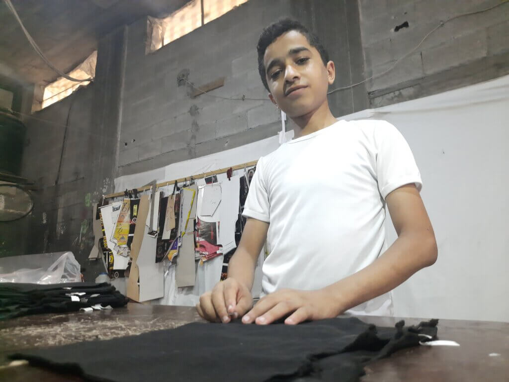 Muhannad at the sewing shop. (Photo by authors)