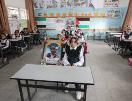 Palestinian students put the photo of Layan Al-Shaer at her seat on the first day of school in Khan Younis on August 29, 2022. Al-Shaer was killed by an Israeli air strike during the latest Israeli attack on Gaza. (Photo: Ashraf Amra/APA Images)