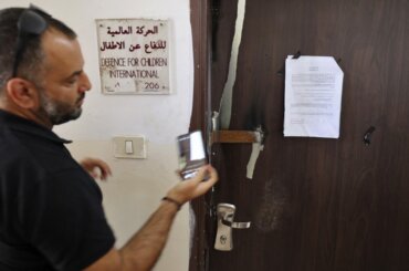 Defense for Children International - Palestine's office door outside Ramallah after Israeli forces conducted a raid and declared the organization closed on August 18, 2022. (Photo credit: AFP / Abbas Momani)