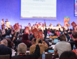 Assembly participants raise orange consensus cards in affirmation of what is said during a closing business plenary at the 11th Assembly of the World Council of Churches, held in Karlsruhe, Germany. (Photo: Albin Hillert/WCC)