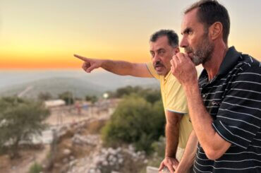Jaafar Ladadweh, 55 and Yousef Ali looking at the settlements across from Naalan, September 2022. (Photo: Mariam Barghouti/Mondoweiss)