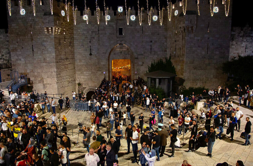 Israeli police and protesters clash outside Damascus Gate after barriers that were put up by Israeli police are removed, allowing access to the main square that has been the focus of a week of clashes around Jerusalem's Old City, April 25, 2021. (Photo: Marihan Al-Khalidi/APA Images)