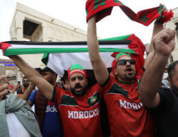 Fans gather in the streets of Doha, Qatar holding Moroccan and Palestinian flags ahead of the World Cup match between Morocco and Portugal on December 10, 2022. (Photo: Ashraf Amra/APA Images)
