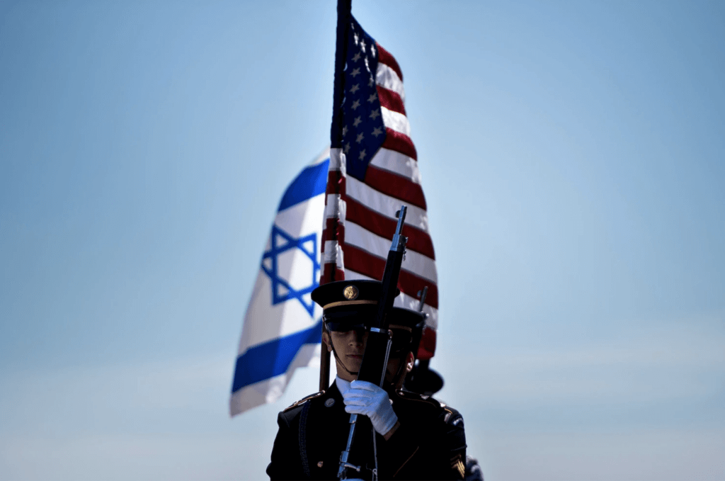 Members of the U.S. military carry the flags of Israel and the United States before the arrival of then Israeli Minister of Defense Avigdor Lieberman in Washington on April 26, 2018. (Photo: Brendan Smialowski/Getty Images)