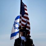 Members of the U.S. military carry the flags of Israel and the United States before the arrival of then Israeli Minister of Defense Avigdor Lieberman in Washington on April 26, 2018. (Photo: Brendan Smialowski/Getty Images)