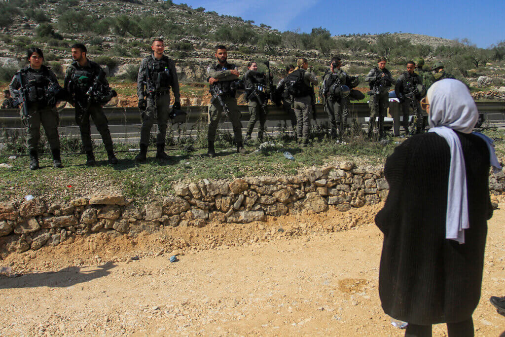 Israeli security forces block activists protesting at the entrance of Huwara in the West Bank, on March 3, 2023, following deadly violence by Israeli settlers. (Photo: Mohammed Nasser/ APA Images)