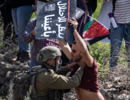 An Israeli security force member grabs a demonstrator by the neck during a march organized by activists from Israel and Palestine on their way to Huwara to show solidarity following the settler rampage there earlier this week, March 3 2023 (Photo: Ilia Yefimovich/dpa via ZUMA Press/APA Images)