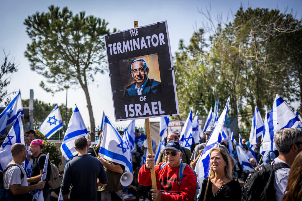 Israeli protesters hold flags and signs during a protest against the Netanyahu government's judicial reforms, outside the Knesset in Jerusalem, February 20, 2023. (Photo: Ilia Yefimovich/dpa via ZUMA Press/APA Images)