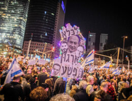 A poster with a portrait of Israeli Prime Minister Benjamin Netanyahu and members of his cabinet that says '' a criminal organization to jail'' during a demonstration in Tel Aviv, January 21, 2023. (Photo: Eyal Warshavsky/SOPA Images via ZUMA Press Wire/APAIMAGES)