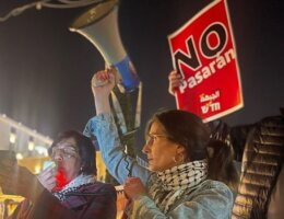 Reem Hazzan holding a megaphone at a protest in Haifa. (Photo: Hadash - Democratic Front for Peace and Equality - Haifa)