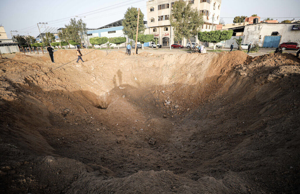 Palestinians inspect a crater after Israel launched air strikes on Gaza, April 7, 2023. (Photo: Abdelrahman Alkahlout/APA Images)