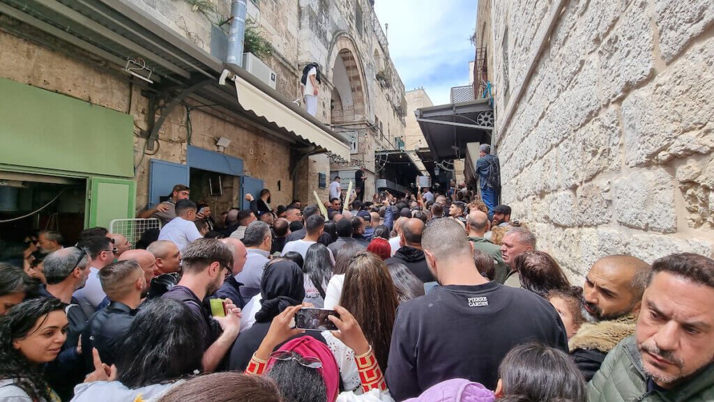 Christian worshipers wait behind a barrier set up by Israeli security forces barring the way to the Church of the Holy Sepulchre in Jerusalem, during the Orthodox Christian Easter Saturday celebrations, on April 15, 2023. (Photo: APA Images)