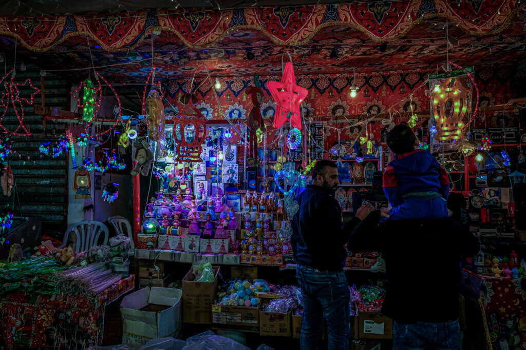 A Palestinian shopkeeper stands outside his decorative lights shop in Gaza City.