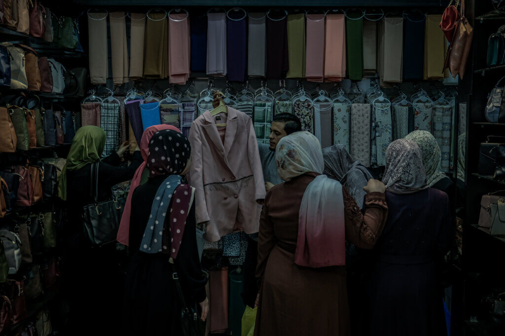 Palestinian women shop for clothes ahead for Eid al-Fitr in Gaza City. (Photo: Mohammed Salem, Mondoweiss)