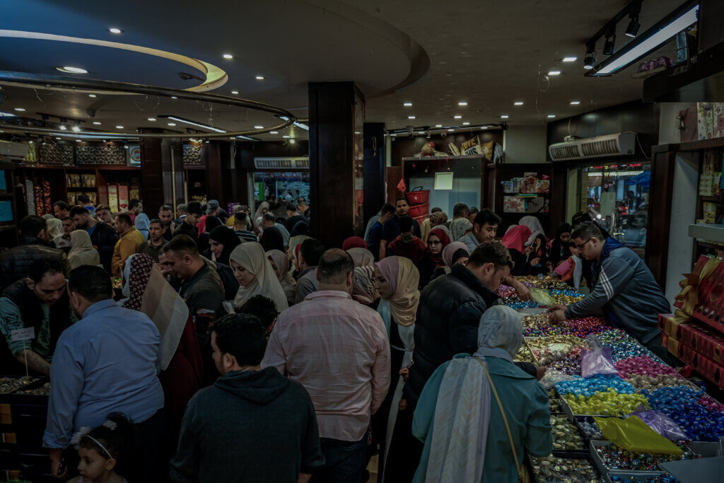 Palestinians in Gaza shop for sweets ahead of the Eid al-Fitr holidays. (Photo: Mohammed Salem, Mondoweiss)