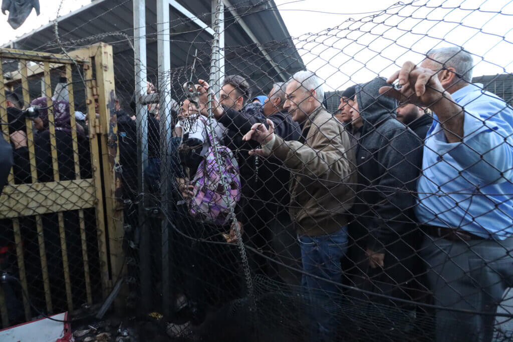 Thousands of Palestinian workers cross the Israeli Eyal checkpoint in Qalqilya, West Bank, on their daily trip to workplaces in Israeli settlements and Palestinian towns behind the Israeli colonial wall, in March 2023. (Photo: Ahmad Al-Bazz, Activestills)