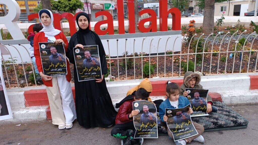 Children of Khader Adnan hold posters of their imprisoned father, at a rally at al-Manara square in Ramallah.