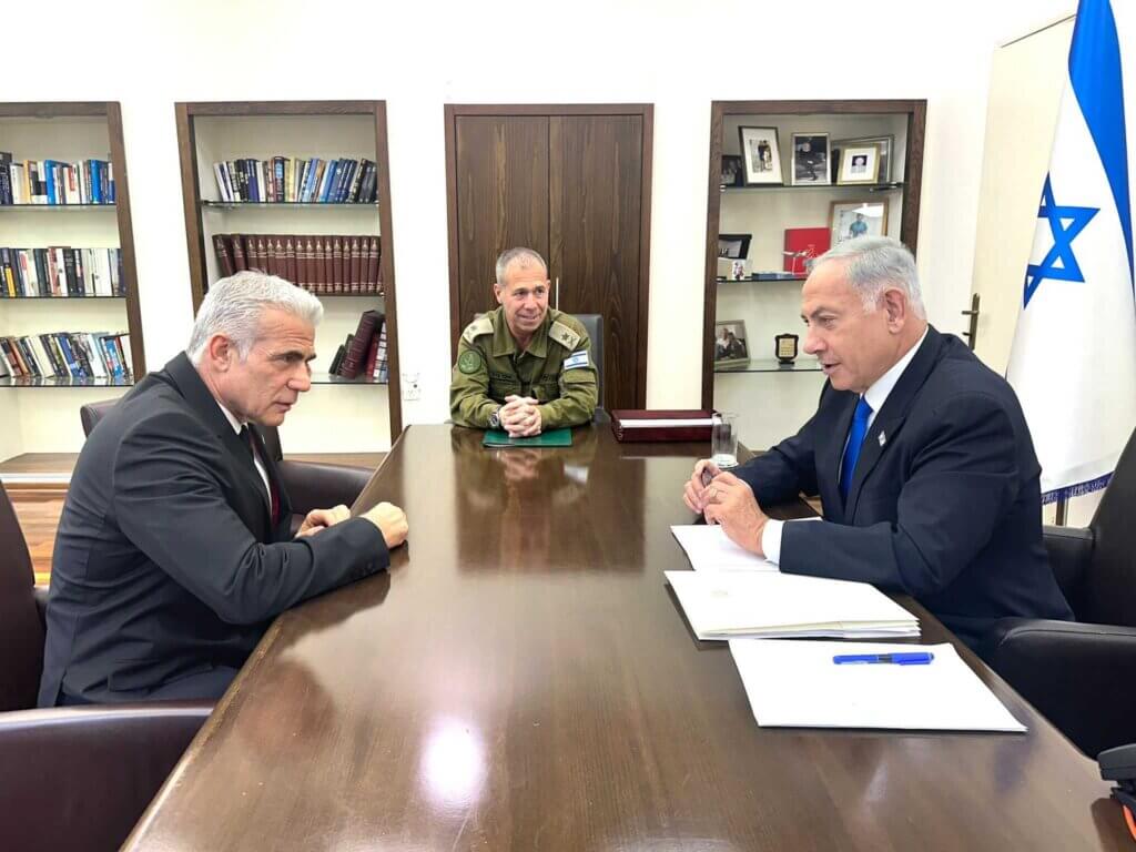 Yair Lapid meets with Benjamin Netanyahu at Israeli military HQ in Tel Aviv on April 9, 2023. (Photo: Israeli Government Press Office)