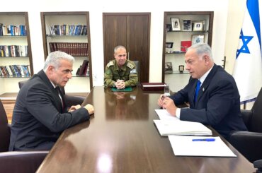 Yair Lapid meets with Benjamin Netanyahu at Israeli military HQ in Tel Aviv on April 9, 2023. (Photo: Israeli Government Press Office)
