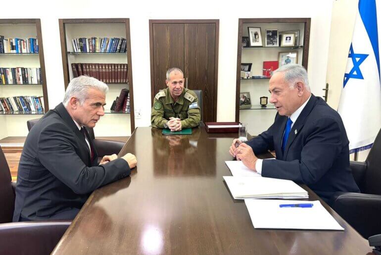 Yair Lapid meets with Benjamin Netanyahu at Israeli military HQ in Tel Aviv on April 9, 2023. (Photo: Israeli Government Press Office)