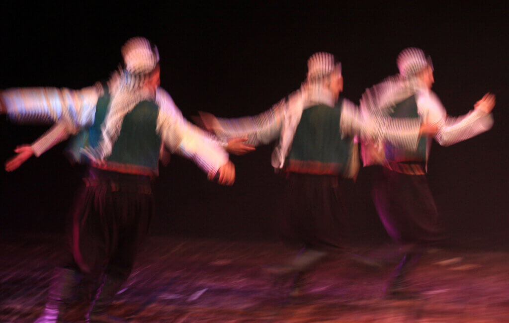 Blurred image of Palestinian actors performing a dance as part of the play, "Qamar wa Sanabel" at the Ramallah Cultural Palace, March 23, 2010.