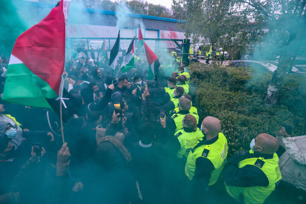 Crowds face off with security personnel outside an Elbit UAV weapons factory to support “Palestine Action” activists who occupied the building for six consecutive days in Leicester, United Kingdom, May 24, 2021. (Photo by Vudi Xhymshiti)