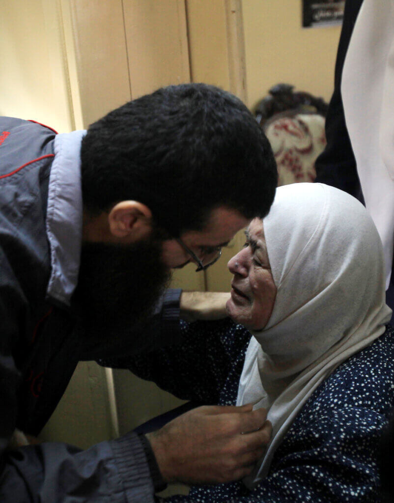 Khader Adnan bends down to greet his crying mother, during his reception in his hometown of Arrabeh near Jenin after being released from Israeli prison on July 12, 2015.