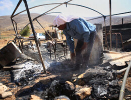 A Palestinian man inspects his a tent burned by Jewish extremists in the area of Ein Samiya in August, 2015. Attacks and intimidation by Israeli settlers and military forces on Ein Samiya have been taking place for years. (Photo: Shadi Hatem/APA Images)