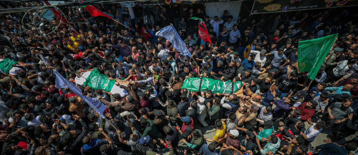 An overhead shot from the funeral of the 12 Palestinian martyrs killed during an overnight Israeli airstrike on Gaza, showing throngs of mourners carrying the bodies of the slain.