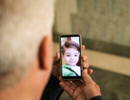 A smartphone held in a man's hands showing the picture of Tamim Dawoud, 4, who was 'scared to death' by the Israeli bombardment in the Rimal neighborhood west of Gaza City, on May 9, 2023.