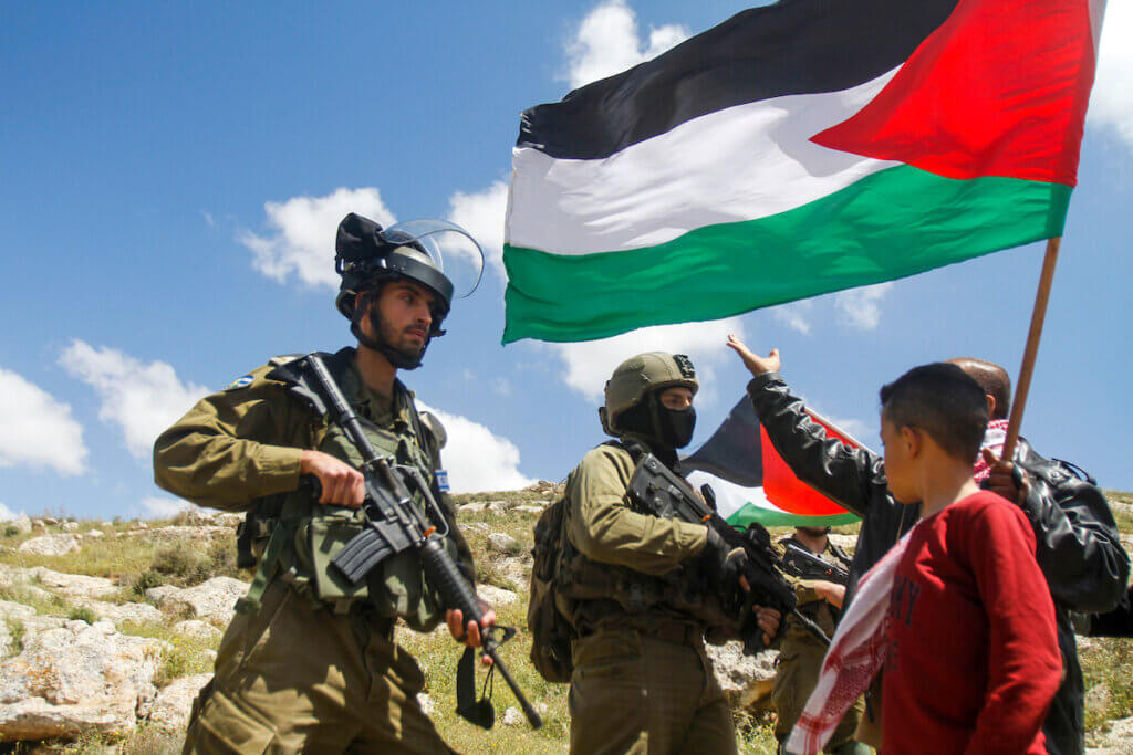 Palestinians block Israeli soldiers during a protest against the expansion of Jewish settlements, on April 28, 2023, in the West Bank village of Beit Dajan, east of Nablus. (Photo: Mohammed Nasser /APA Images)