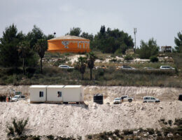 A zoomed-in photo taken from a distance of an Israeli trailer constructed on a hilltop, belonging to Israeli settlers who are setting up a Yeshiva in the former Homesh outpost.