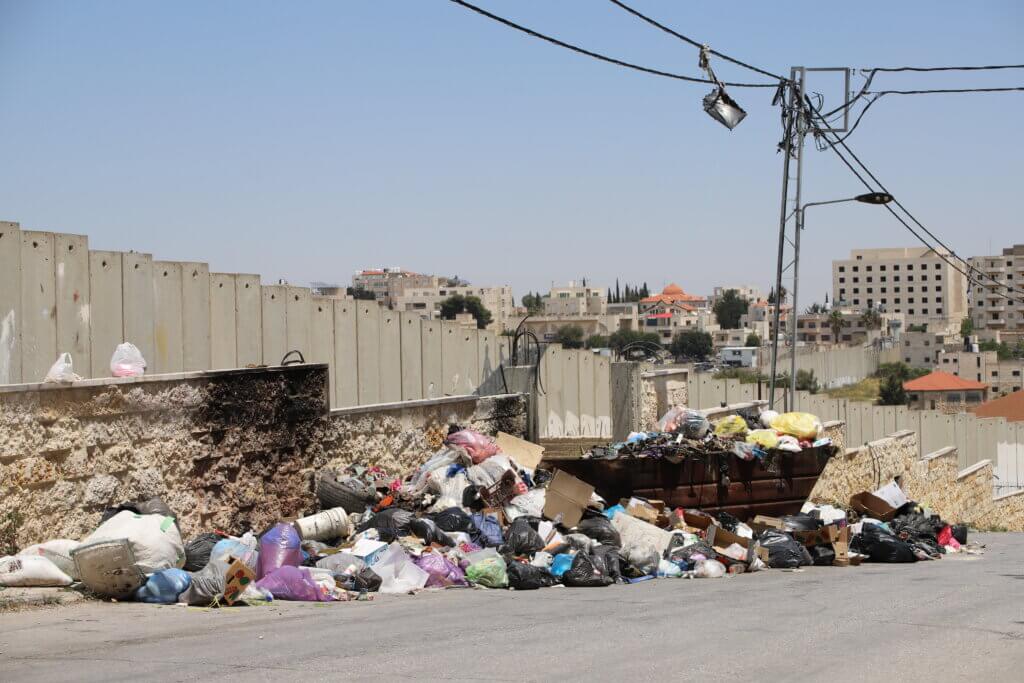 The trash dump in the Aida refugee camp has been overflowing, ever since sanitation workers employed by UNRWA have gone on strike over low wages and lack of job security. (Malik Hamamra/Mondoweiss) Aida Refugee Camp, occupied West Bank, May 2023.