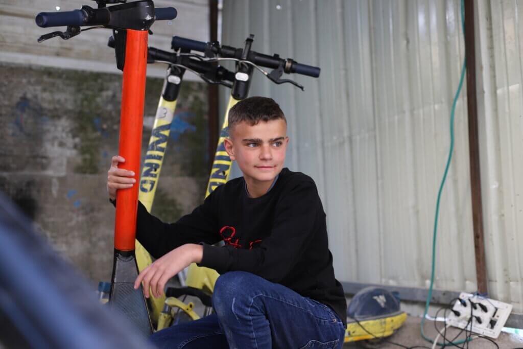 Ameer Jado rents out electric scooters to other kids in the camp. He says it earns him some extra cash, but also gives him something fun to pass the time with. (Malik Hamamra/Mondoweiss) Aida Refugee Camp, occupied West Bank, May 2023. 