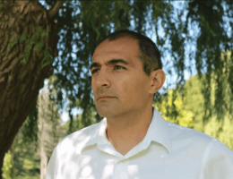 A photo of Dr. Nader Hashemi standing under a tree.