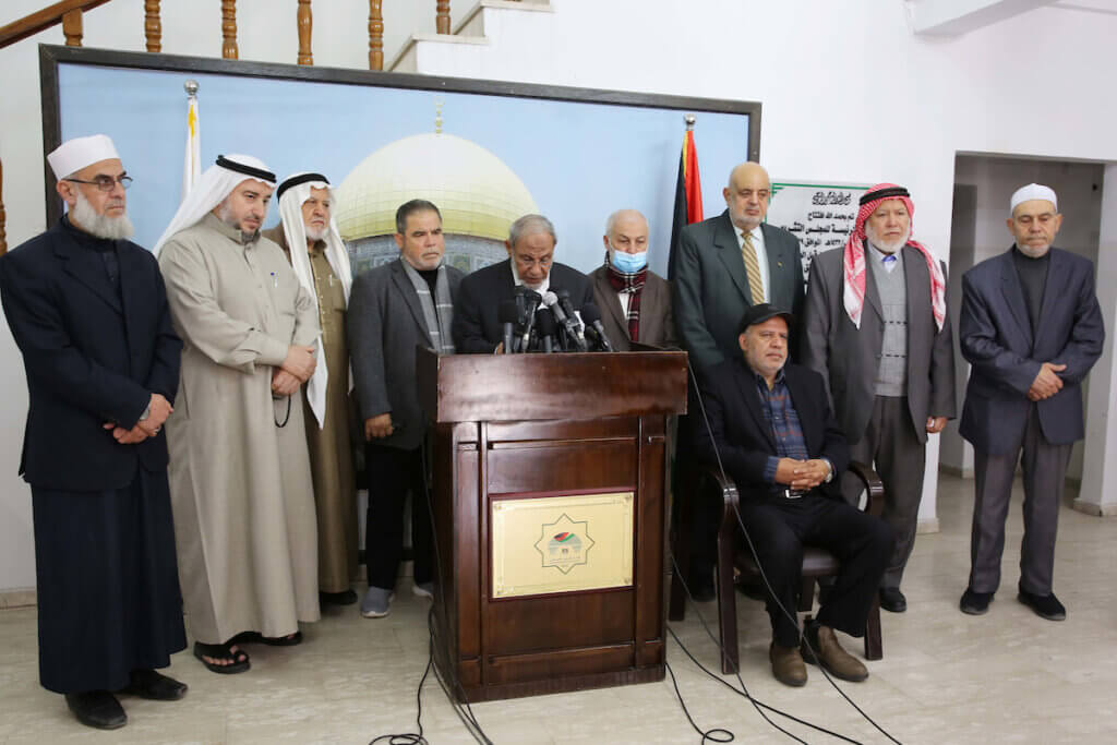 Chairman of the Political Committee at the Palestinian Legislative Council, Mahmoud al-Zahar, speaks during a press conference in Gaza City, on March 1, 2023, while flanked by other members of the Council as he stands at a podium.