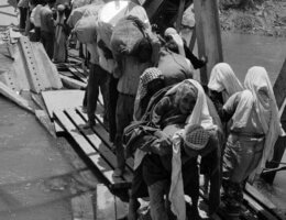 In this 1967 photo from the U.N. Relief and Works Agency, UNRWA, archive, Palestine refugees flee across over the Jordan river on the damaged Allenby Bridge during the 1967 Arab-Israeli war.