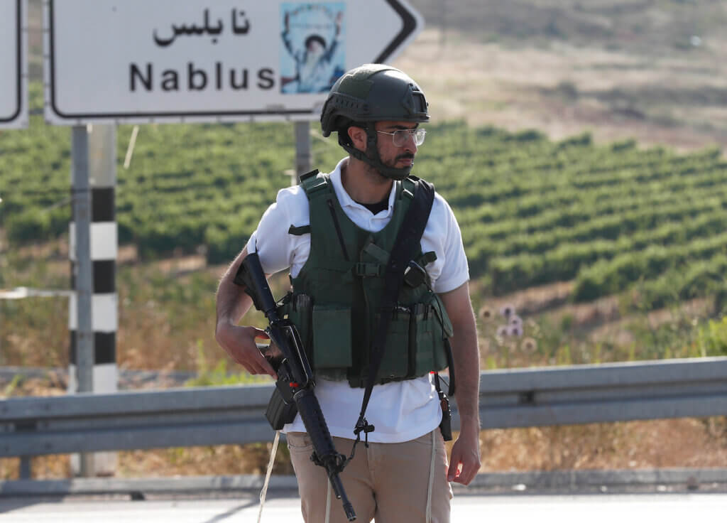 Israeli military officers stand guard at a road leading to the Israeli settlement of Eli, between Nablus and Ramallah, in the West Bank, 20 June 2023, following a shooting incident that killed four people, June 20, 2023. (Photo: Atef Safadi/EFE via ZUMA Press/APA Images)