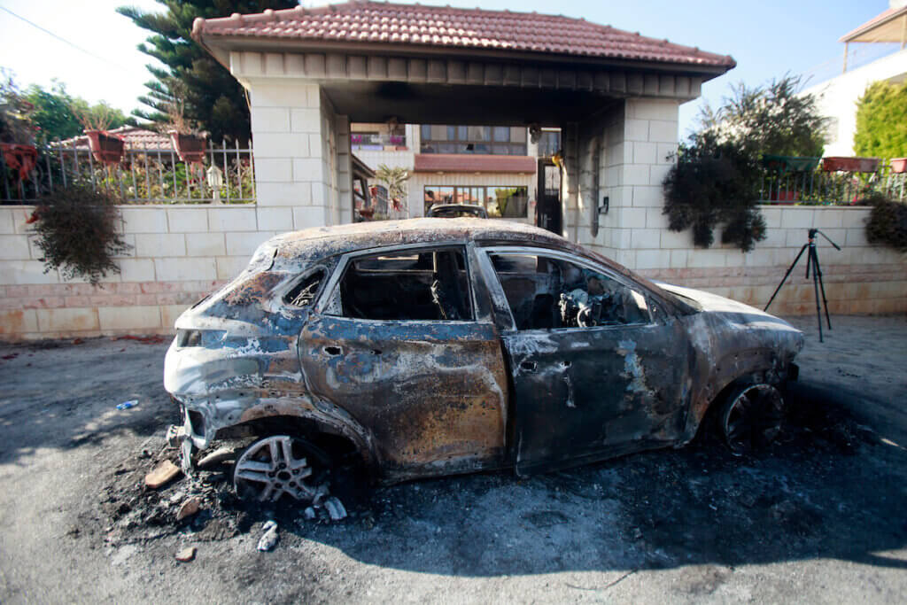 A car set on fire by Israeli settlers in front of a house in Turmus Aya, near the West Bank city of Ramallah, on June 21, 2023. (Photo: Mohammed Nasser/ APA Images)