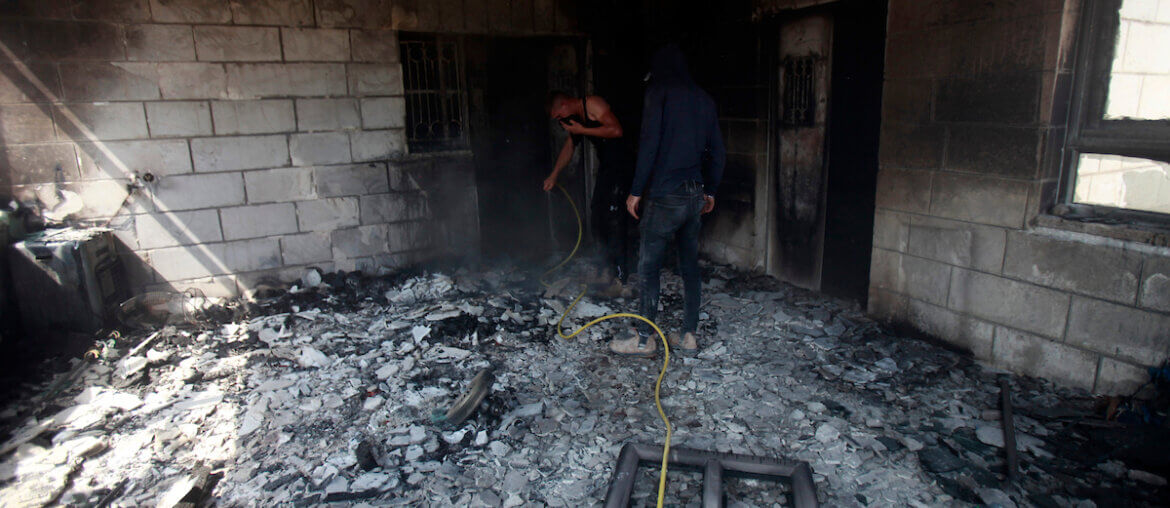 Palestinians inspect a house set on fire by Israeli settlers in the Palestinian village of Turmus Aya, near Ramallah, June 21, 2023. The photo portrays the charred remains inside one of the rooms in a house that was the target of the attack.