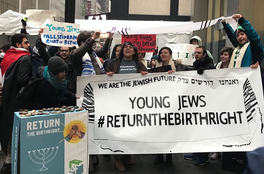 Students protesting outside of the Ziegfeld Ballroom in New York City, April 15, 2018. Protesters hold a large banner which reads: "Young Jews #returnthebirthright"
