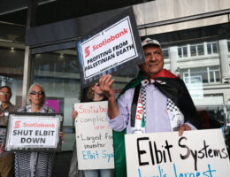 Palestine solidarity activists hold posters and signs in Vancouver Canada during a rally outside the Scotiabank Towers to protest the bank's investment in Elbit Systems, June 3, 2023. (Photo: Michael YC Tseng)