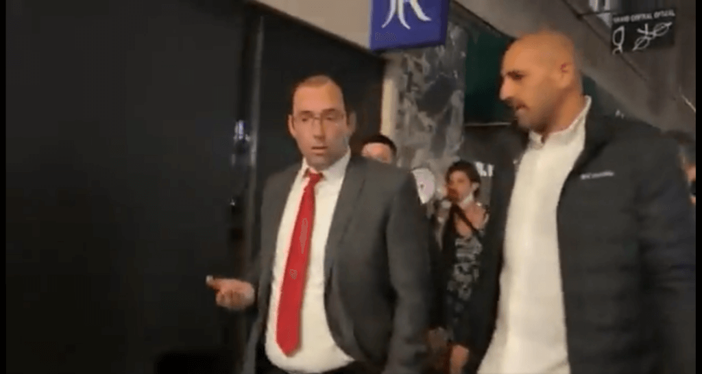 Simcha Rothman, member of the Israeli knesset for a racist party Jewish Power, is heckled on the streets of NY, June 2, 2023. Moments later Rothman tore the megaphone from the hands of one of his pursuers. Screenshot from Shany Granot-Lubaton video on twitter.