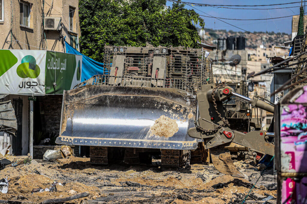 An Israeli military bulldozer seen leveling roads and destroying the center of the Jenin refugee camp during a raid on the camp near the West Bank city of Jenin, July 3, 2023. (Photo: Nasser Ishtayeh/SOPA Images via ZUMA Press Wire/APA Images)