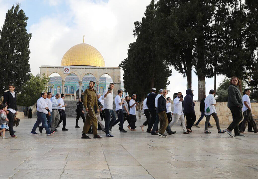 Israeli police accompany a group of Jewish settlers as they storm past the Dome of the Rock in the Al-Aqsa compound in Jerusalem, May 5, 2022.