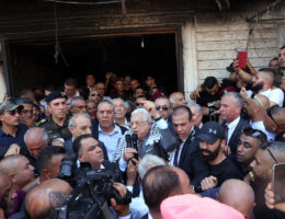 Palestinian Authority president Mahmoud Abbas surrounded by a crowd of security personnel and fellow PA and Fatah officials as he addresses a crowd in Jenin refugee camp, in the wake of the most wide-ranging Israeli military invasion of the camp since the Second Intifada.