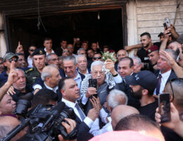 Palestinian Authority president Mahmoud Abbas surrounded by a crowd of security personnel and fellow PA and Fatah officials as he addresses a crowd in Jenin refugee camp, in the wake of the most wide-ranging Israeli military invasion of the camp since the Second Intifada.