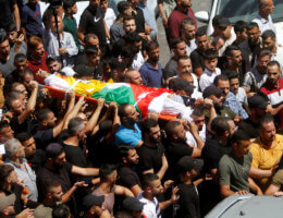 Throngs of mourners carry the flag-draped body of Bader al-Masri, who was killed by the Israeli army as it secured the entrance of Israeli settlers to Joseph's Tomb in Nablus, July 20, 2023.