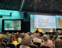 Peter Makari, on the screen to the left, speaks in support of the resolution "Compelled to Witness: Answering the Cry of Our Palestinian Siblings" at the Christian Church (Disciples of Christ) biennial General Assembly in Louisville, Kentucky, July 29, 2023. (Photo: Social Media/Christian Church in Ohio, Disciples of Christ)