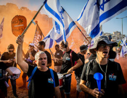 Anti-judicial reform protestors stand in orange smoke waving the Israeli flag during a demonstration in the illegal Har Homa settlement on July 5, 2023. Over 200 protesters demonstrated in front of the Har Hamor yeshiva headed by Rabbi Zvi Tau, which the protesters say symbolizes the messianic stream leading the government's judicial overhaul. (Photo: Eyal Warshavsky/SOPA Images via ZUMA Press Wire/APAIMAGES)